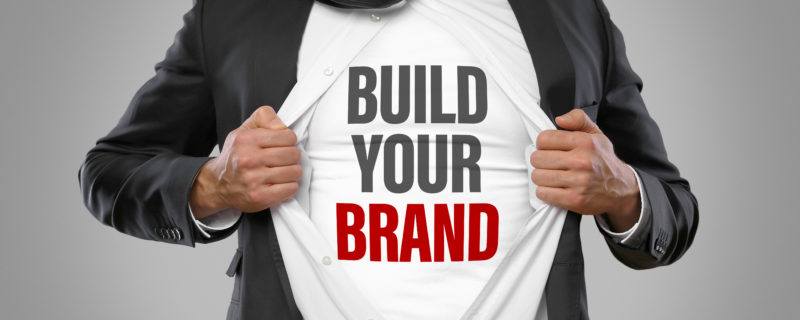 A man wearing a shirt that says "Build Your Brand"