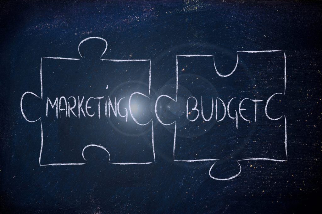 union of marketing and budget as complementary elements of business, jigsaw puzzle