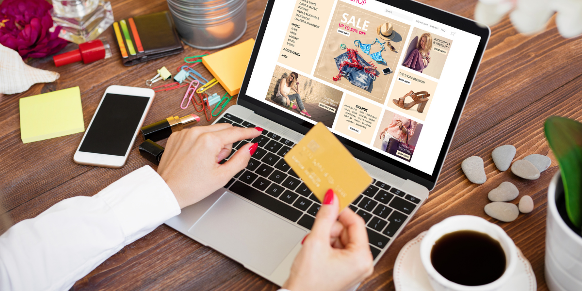 A woman shopping online and holding a credit card